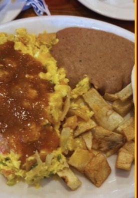 Breakfast plate with huevos rancheros, beans, and potatoes at Camino Real