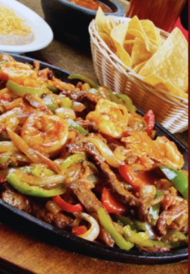 Sizzling beef and shrimp fajitas at Camino Real